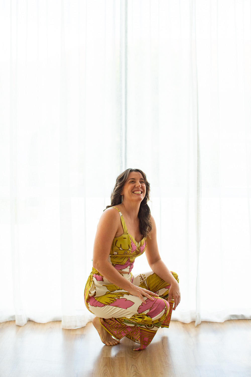 Emma-Kate, founder of MUSE, smiling in a bright studio space, sharing her journey into Pilates teacher training and mentorship in Australia.